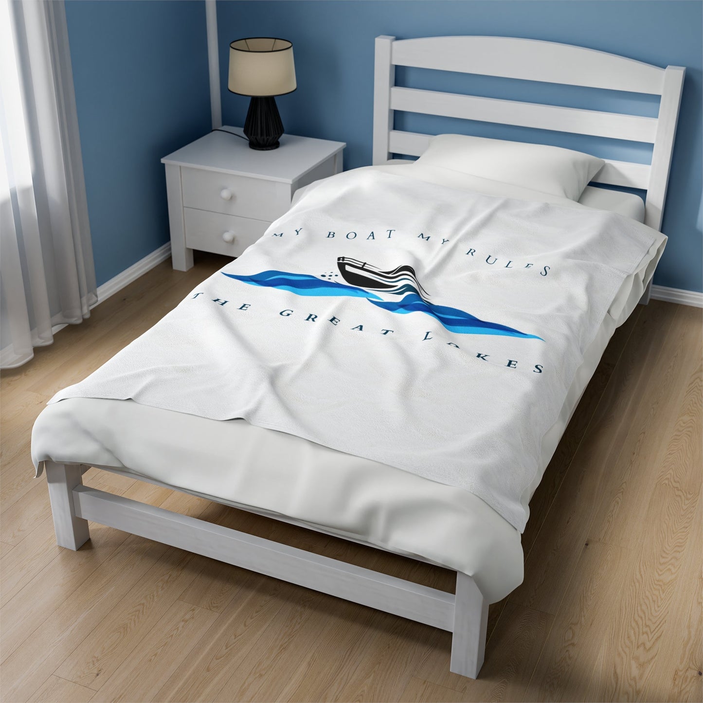 Plush velveteen blanket with "My Boat My Rules-The Great Lakes" design on bed, in various sizes.